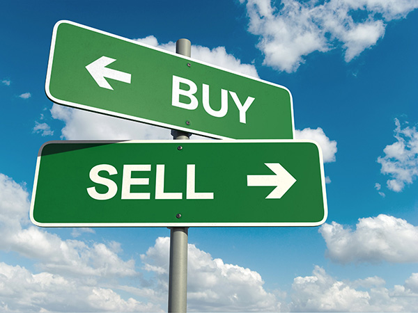 A pair of street signs that say Buy and Sell